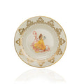 Fine bone china decorative plate with gold filigree rim and seated figure illustration