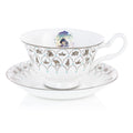 Fine bone china teacup and saucer set, white with blue floral band and character medallion
