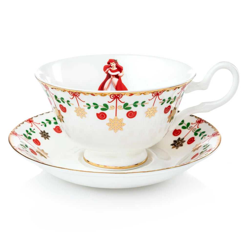 Christmas teacup and saucer, white with red green holiday pattern and Ariel figurine