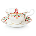 Christmas teacup and saucer, white with red green holiday pattern and Ariel figurine