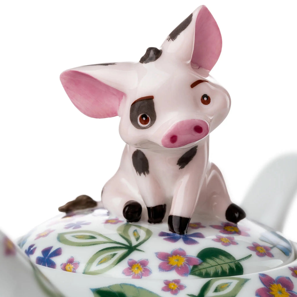 Bone china cow lid ornament on teapot; pink snout and spotted face over floral pattern