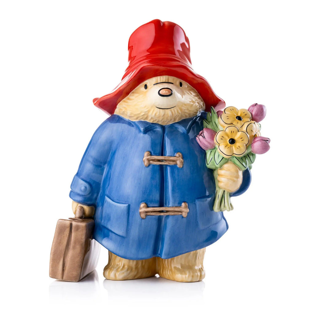 Fine bone china figurine of bear in red hat holding a bouquet of flowers