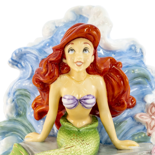 Fine bone china mermaid figurine close view, red hair and purple shell top on blue clouds
