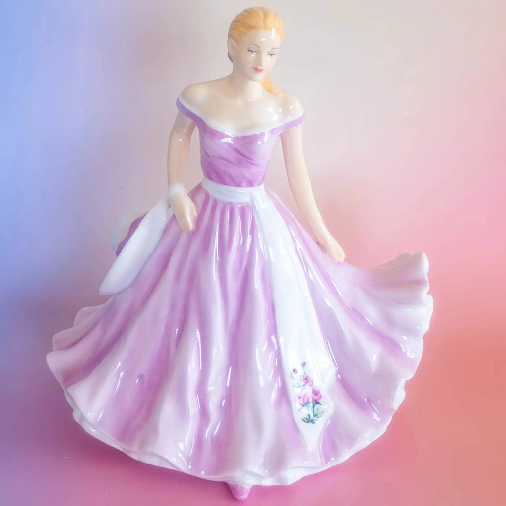 Rose-themed porcelain figurine in purple and white flowing off-shoulder dress