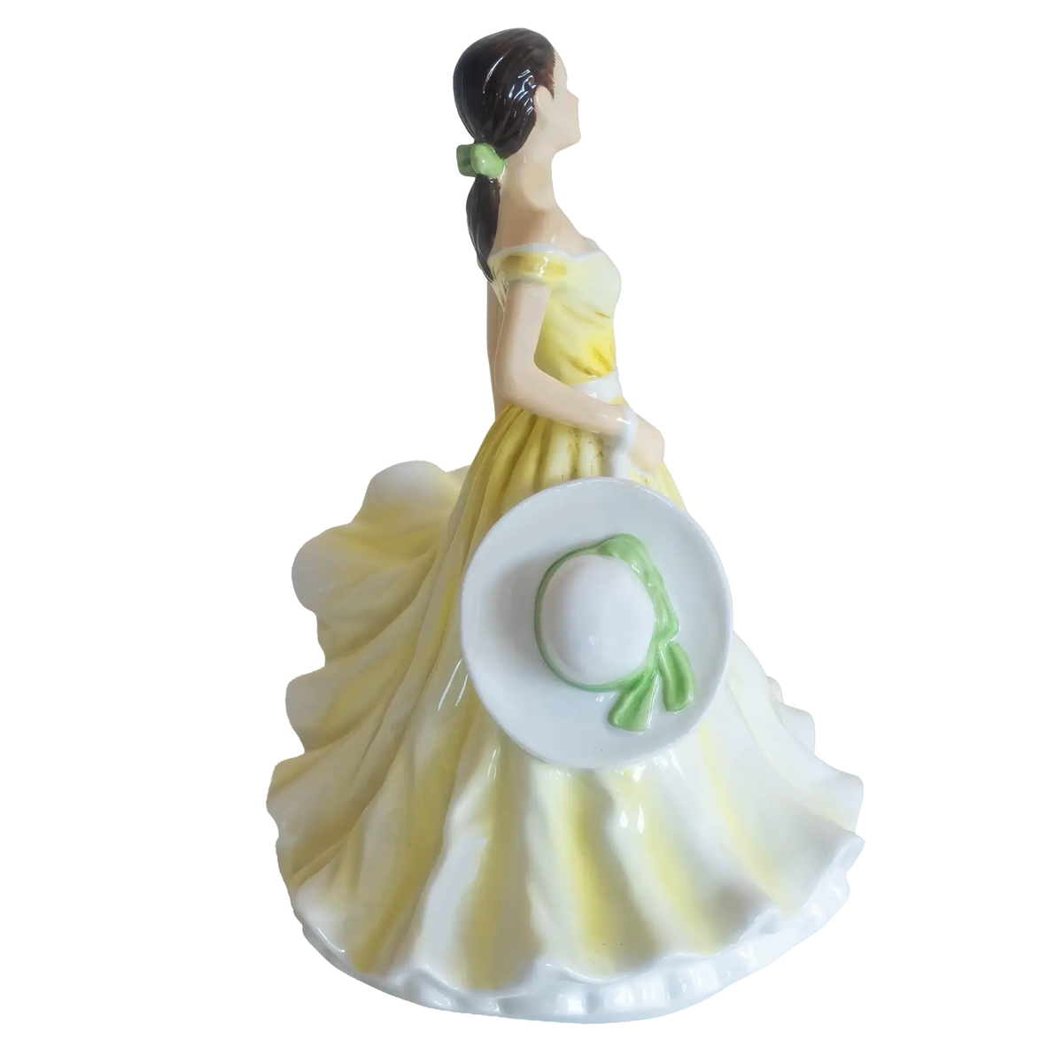 Fine bone china daffodil figurine: rear three-quarter view with white bonnet and yellow skirt