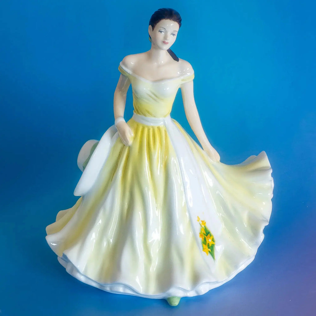 Fine bone china daffodil figurine: full figure in flowing yellow skirt with painted flower on hem