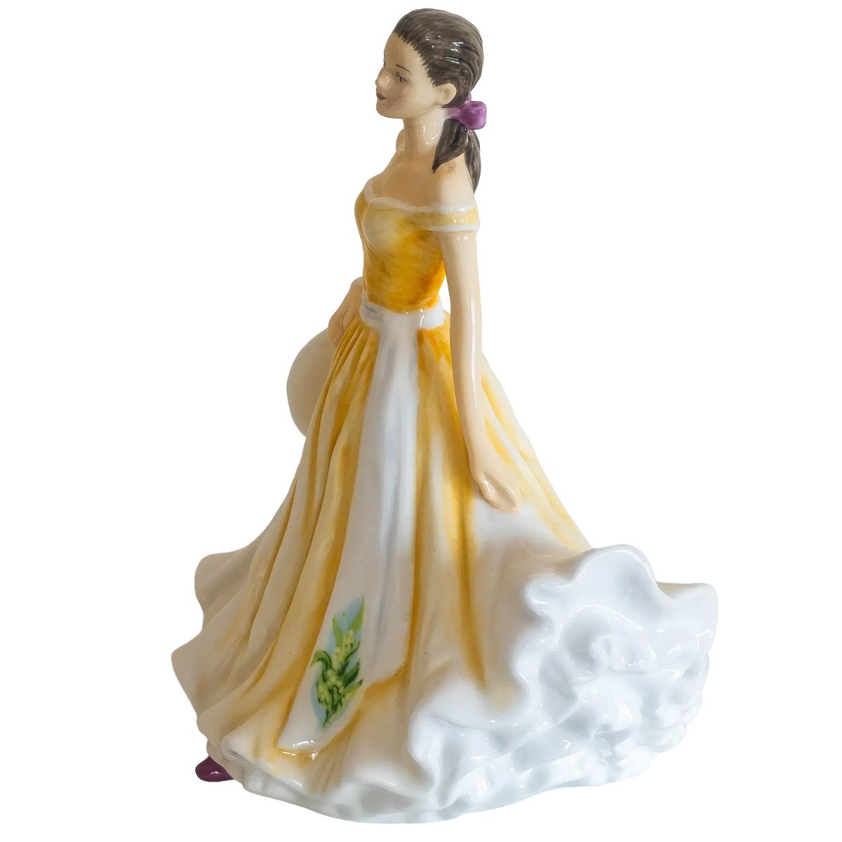 Porcelain female figurine side view in yellow dress with white ruffled hem and purple hair accents